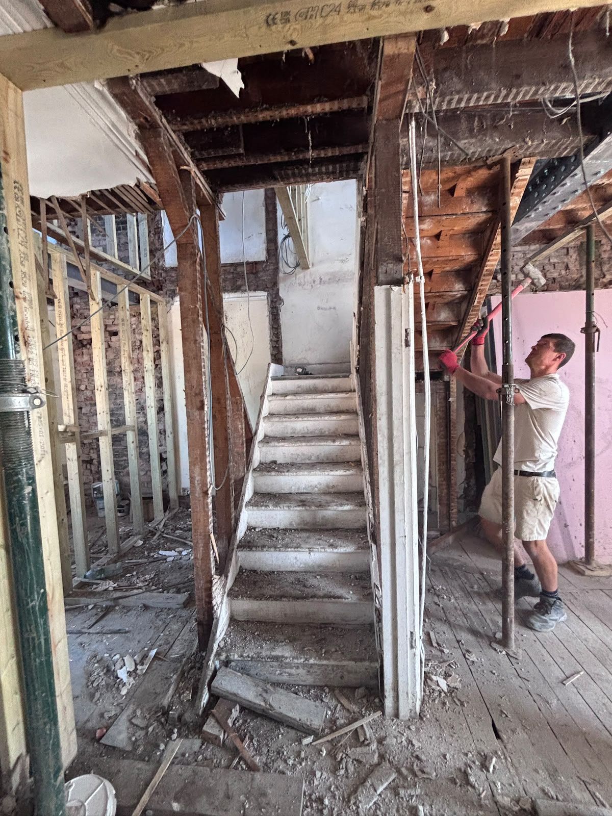Controlled internal demolition beside the original staircase with acrow props supporting the ceiling, Friern Barnet N11