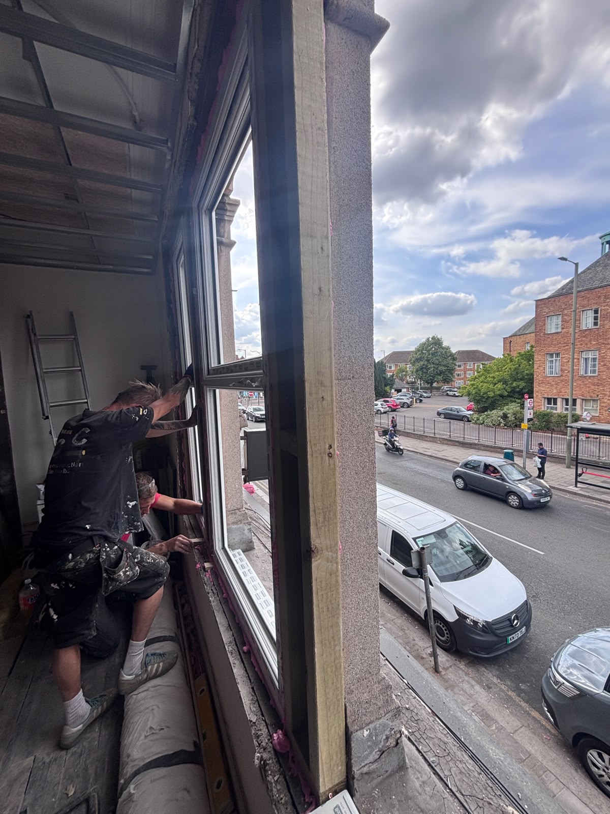 Workmen finishing the trim on a new loft window during the Friern Barnet dormer conversion