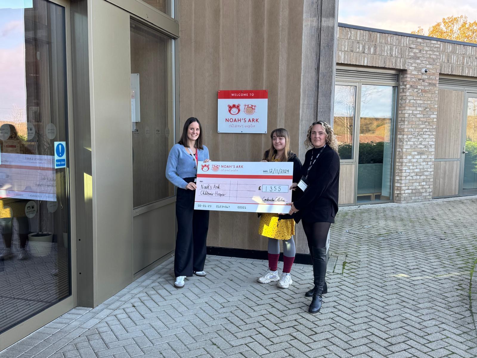 Construction Collective team presenting a charity donation cheque to Noah's Ark Children's Hospice outside their Barnet hospice building