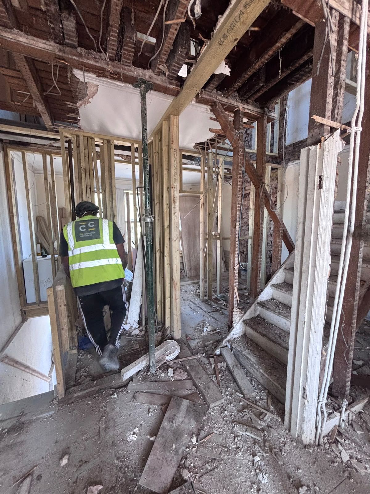 Our team working through the stripped-out first floor with stud partitions framed and a temporary acrow prop in place, Friern Barnet N11