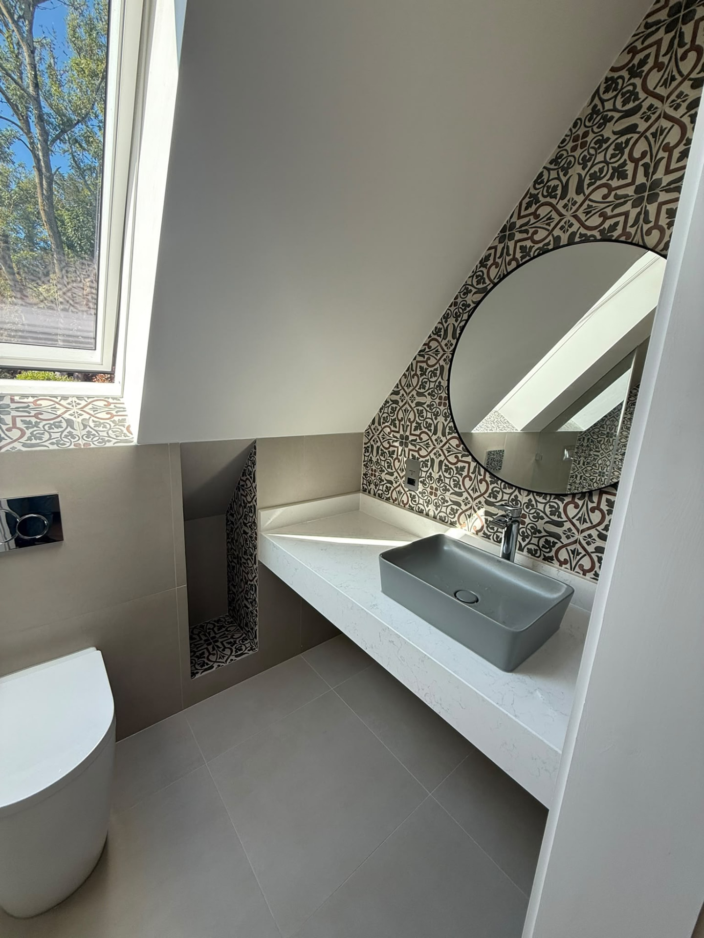 Bespoke garage conversion in Totteridge North London - The Construction Collective - vanity unit with stone worktop and round mirror