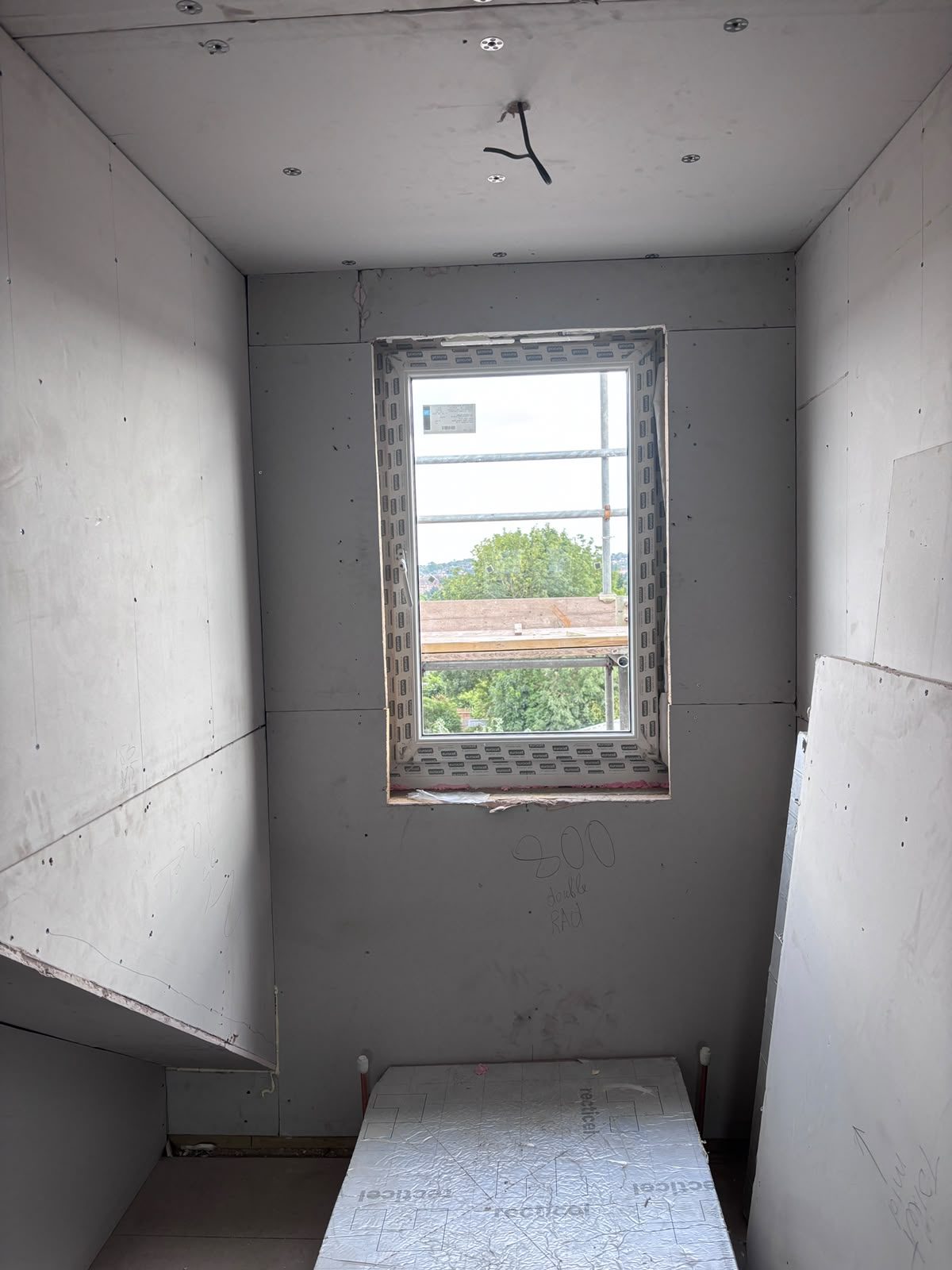 Dormer window opening drylined in plasterboard with PIR insulation and radiator first-fix pipework, Friern Barnet N11