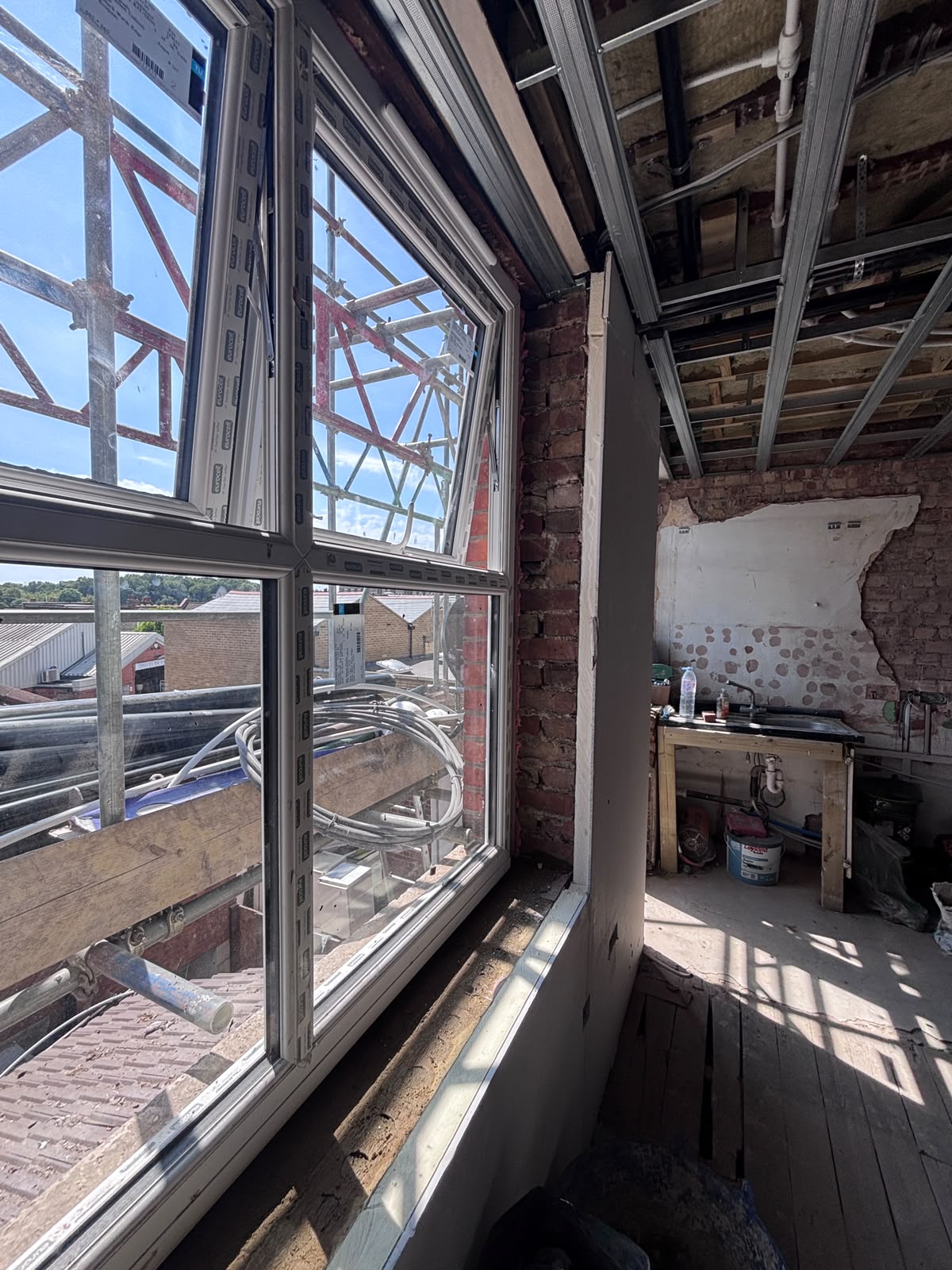New uPVC window fitted in the Friern Barnet loft conversion with scaffolding visible outside