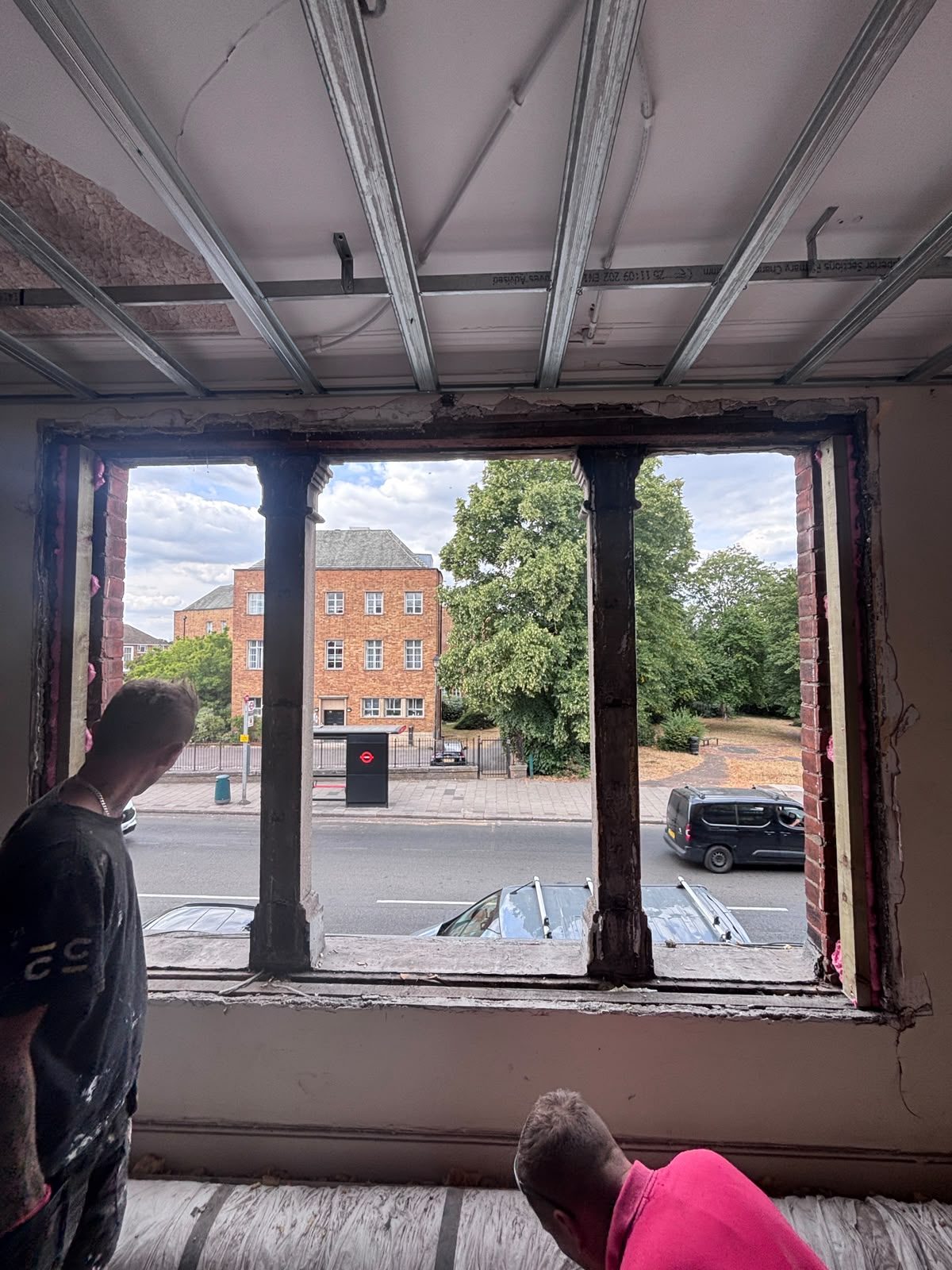 Original masonry window opening stripped back to its piers beneath new metal ceiling furring channels, Friern Barnet N11