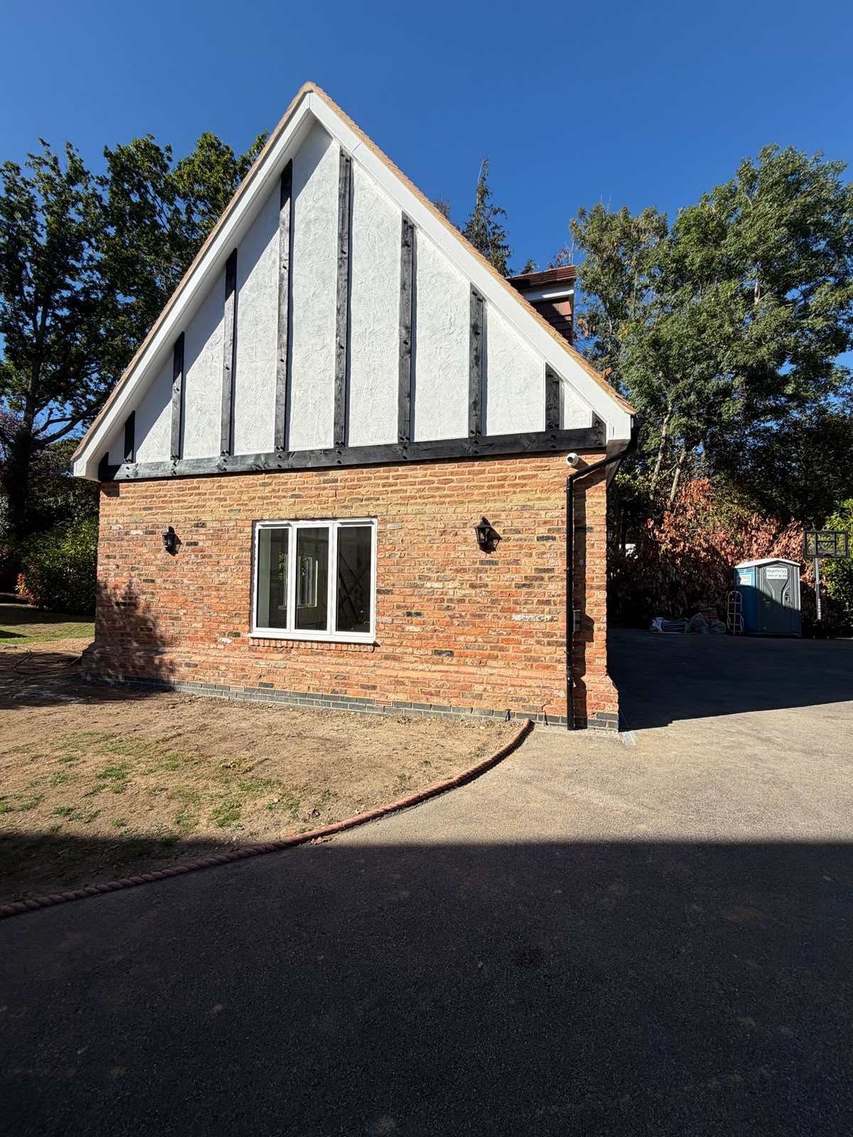Daytime gable elevation of the Totteridge garage conversion with Tudor-style timber detailing